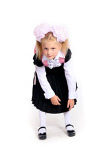 Young girl in school uniform posing in studio on white