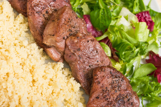 Tenderloin steaks in wine sauce with cadamon and kuskus groats