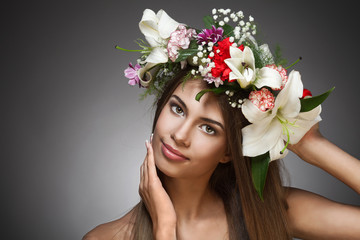 Beautiful woman with flower wreath. Space for text.