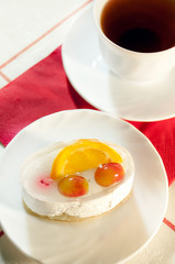 Delicious cake with fresh fruit and tea