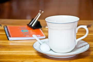 Cup of coffee on a wood background.