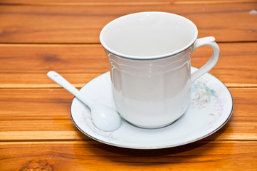 Cup of coffee on a wood background.