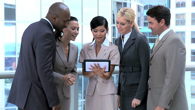 Ambitious Business Executives Using Wireless Tablet 
