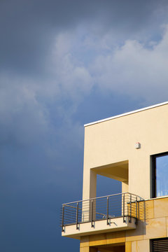 balcony of modern flat with dark clouds in rain