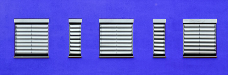 pattern of windows with blue wall