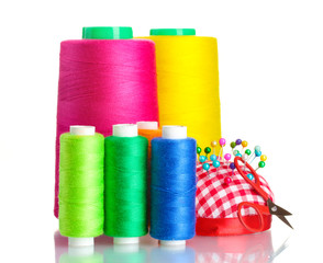 Bobbins of thread with colored pinheads in pin-cushion isolated