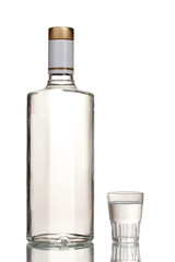 Bottle of vodka and wineglass isolated on white