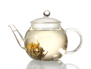 exotic green tea with flowers in glass teapot isolated on white