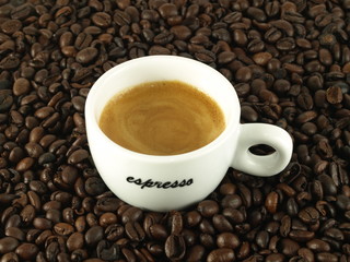 Espresso morning coffee with beans as a background