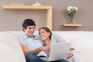Fototapeta premium Couple with their notebook on the sofa