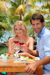 Young couple enjoying lunch in resort restaurant