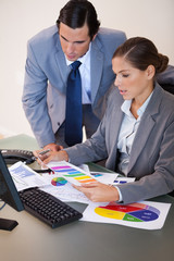 Businesswoman explaining statistics to her colleague