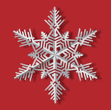 Vector image  of the snowflake with the shadow made of  cut paper isolated on the red background.