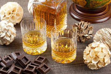 Chocolate and fine scotch whisky in crystal tumblers