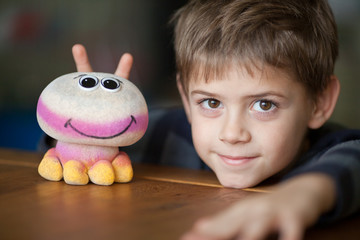 Smiling Boy and Alien Toy  with Antennas