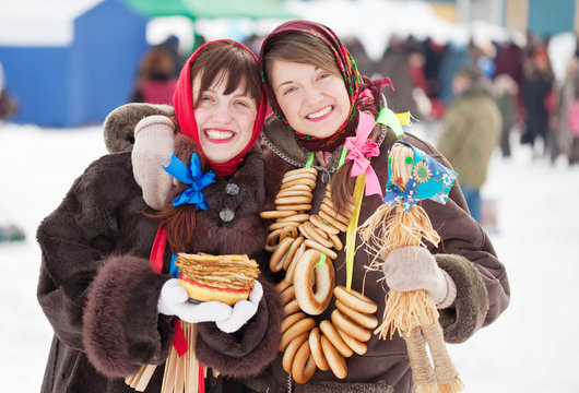 girls with pancake and round cracknel during  Shrovetide