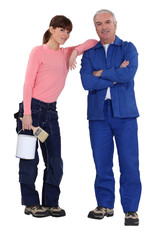 Father and daughter preparing to paint house