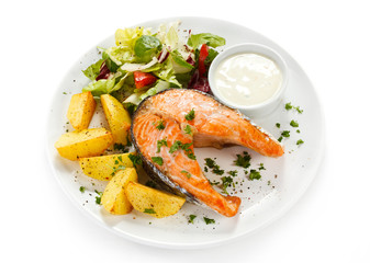 Grilled salmon, baked potatoes and vegetables