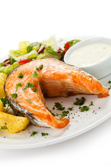 Grilled salmon, baked potatoes and vegetables