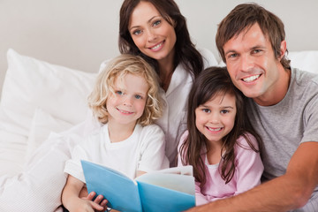Happy family reading a book