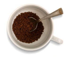White cup with instant coffee granules. View from above with cli