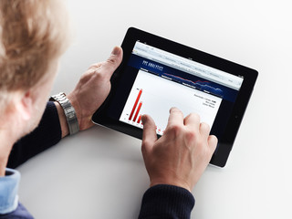 Adult man doing analysis on his tablet pc