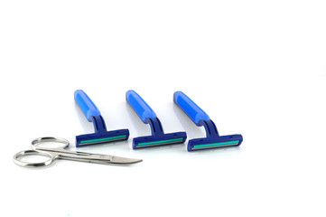 Three blue razors and scissors over white