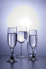 Alcoholic glasses line next to each other.