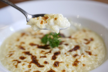 risotto dish with herbs on wood background