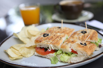 Sandwich with orange and coffee