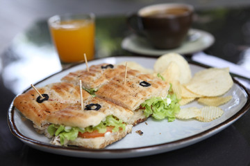 Sandwich with orange and coffee