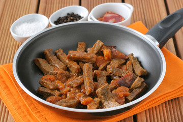 fried beef with sausages and carrot