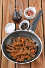 fried beef with sausages and carrot