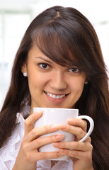 Beautiful businesswoman drinking coffee in the office.