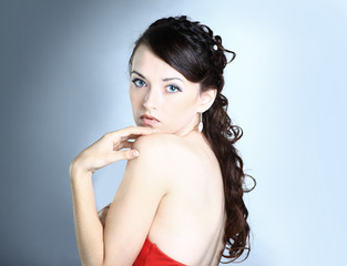 Beautiful girl in the red dress. Isolated on black-
