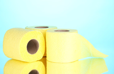 yellow rolls of toilet paper on blue background