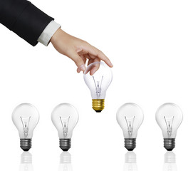 light bulb held between fingers