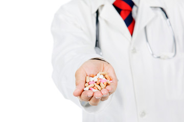 Close up of doctor showing pills against white background