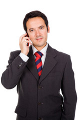Young smiling businessman talking on mobile phone on white backg