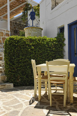 Greek restaurant terrace with table and chairs in Matala