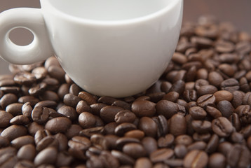 White cup with coffee beANS