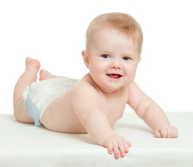 funny baby boy lying on tummy isolated on white background