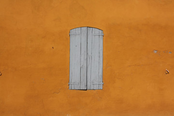 closed window on yellow wall