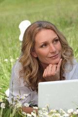 Woman on laptop in field