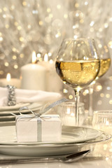 Festive table setting with silver ribbon gift