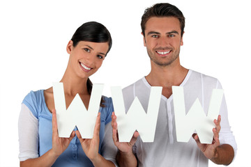 Man and woman holding letters