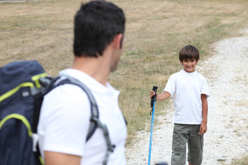 Naklejka premium Man and little boy hiking