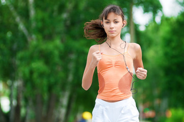 Teenage girl running in green park