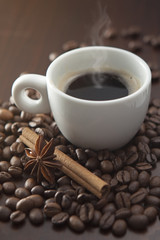Cup of hot coffee with cinnamon and anise