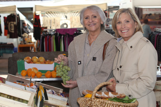 Two Senior Women Shopping At The Market